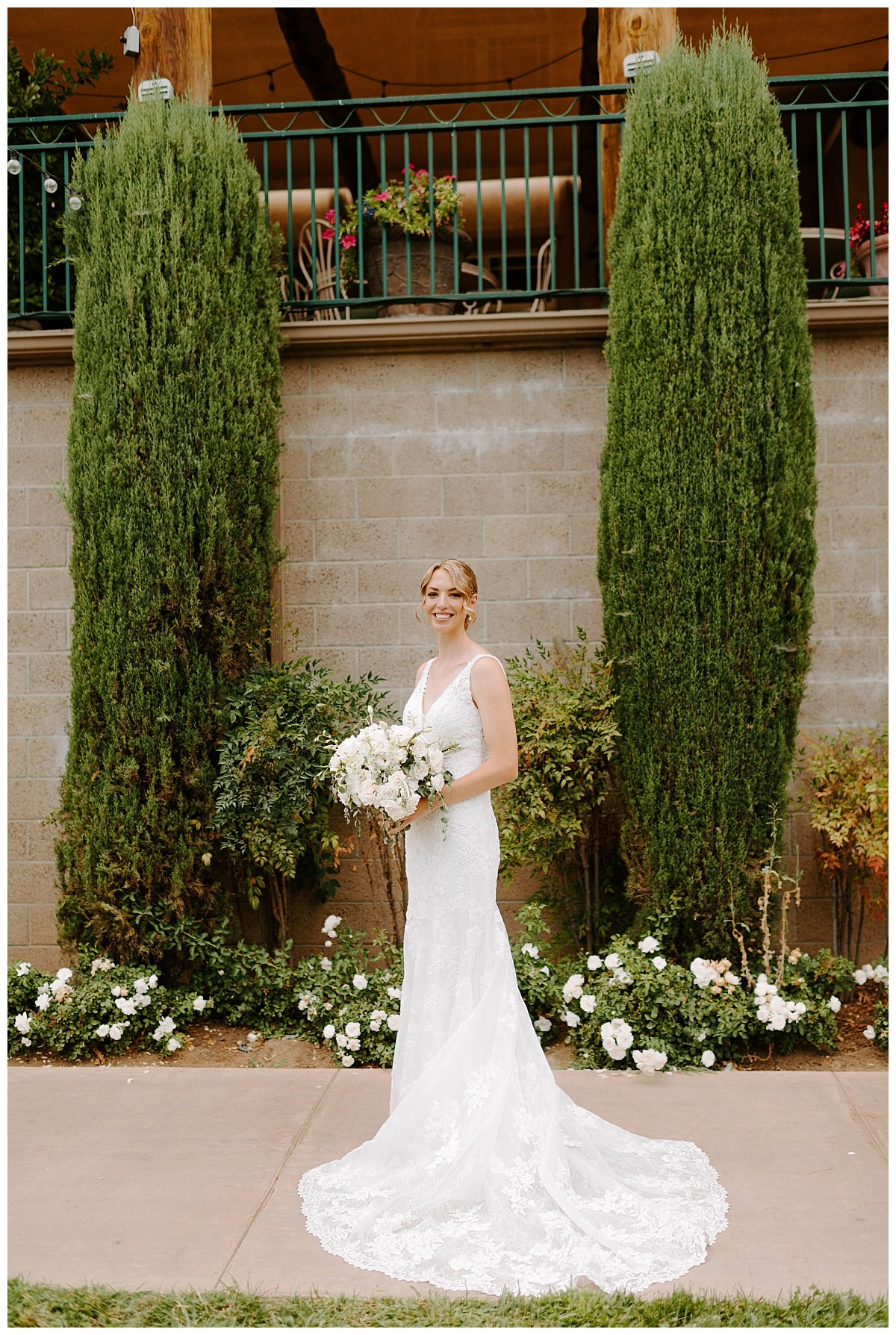 bride in lace floral gown and white rose wedding bouquet for wedding at the south coast winery