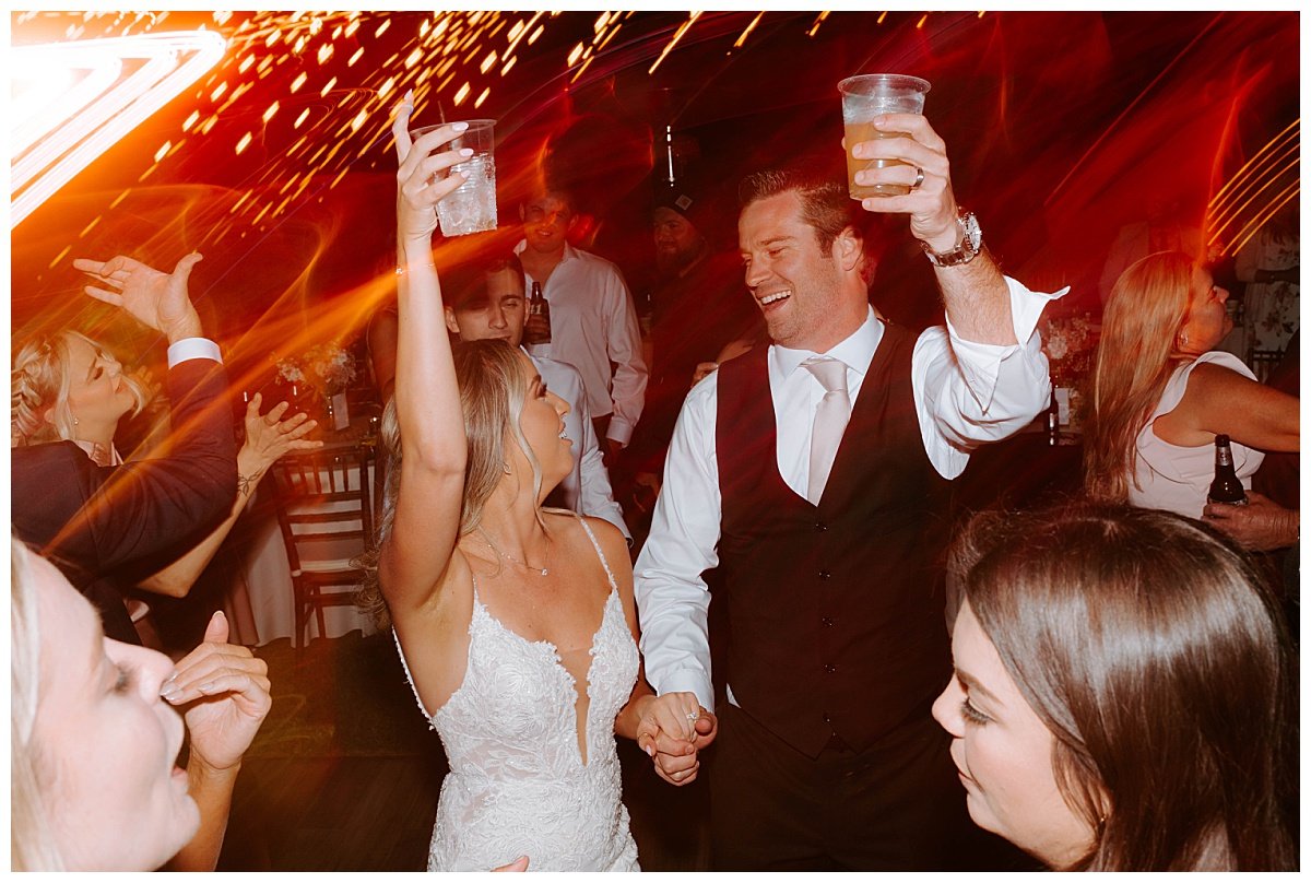 BRIDE AND GROOM DANCING DURING WEDDING RECEPTION FOR SPRING WEDDING AT THE HAWK RANCH WEDDING VENUE